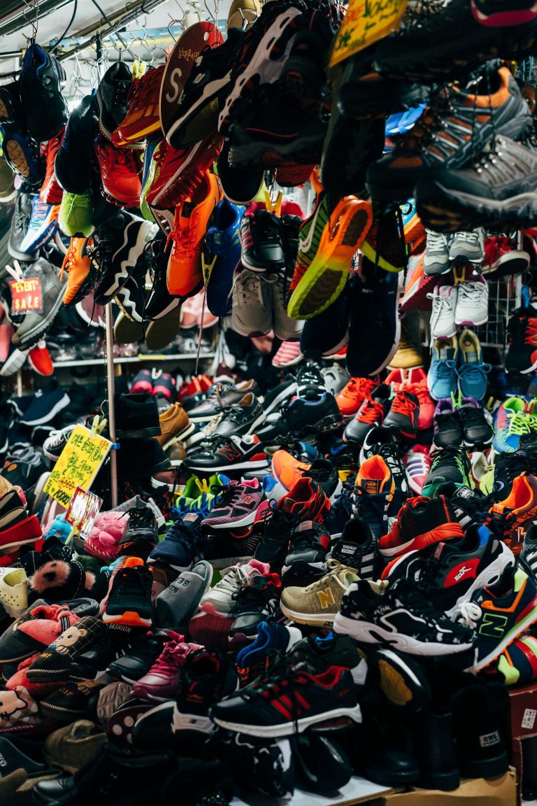 A bustling sneaker store with an array of colorful shoes on display, perfect for footwear enthusiasts.