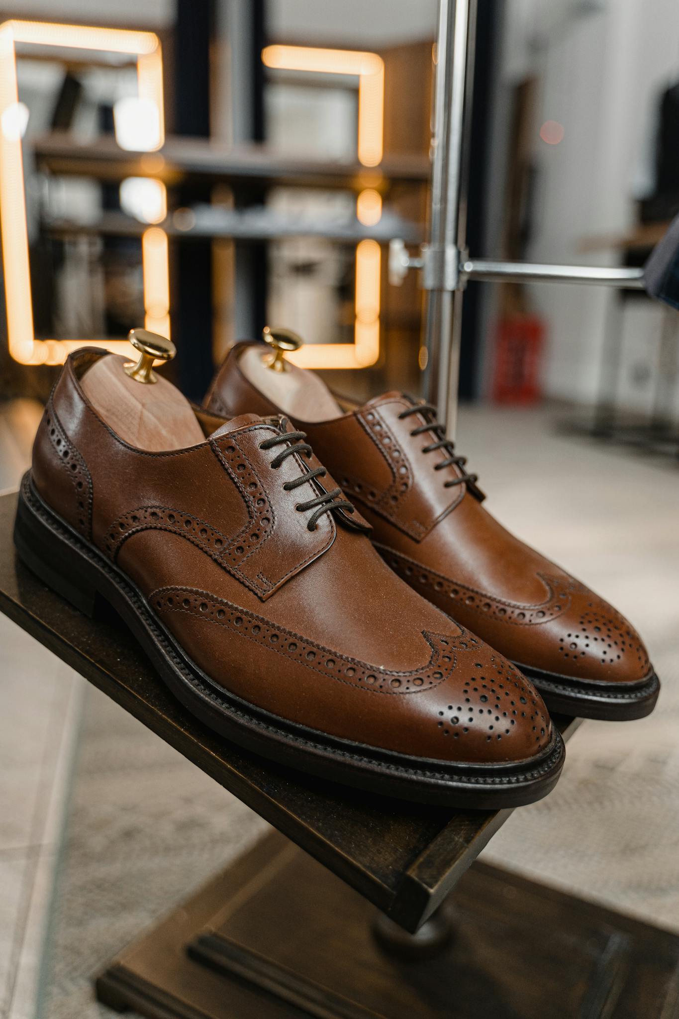 Pair of classic brown leather brogue shoes showcased in a stylish setting.