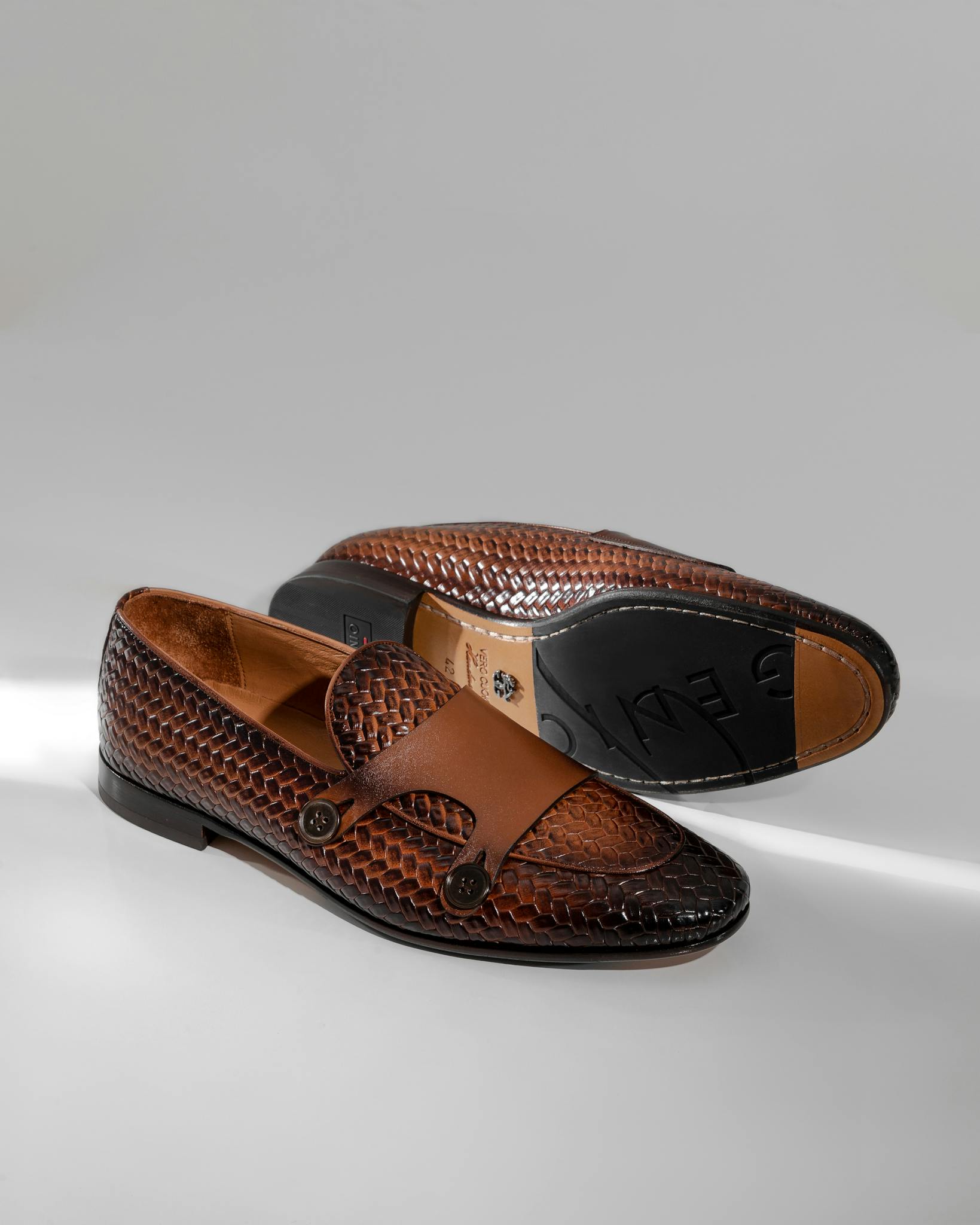 Stylish brown leather loafers with textured design, ideal for menswear fashion.